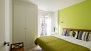 Seville Apartment - Bedroom with twin beds, fitted wardrobe and a large window.