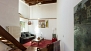 Séville Appartement - View towards the living area. With high wood beamed ceilings and terracotta flooring.