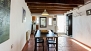 Sevilla Apartamento - Dining area with table and chairs. Beyond is the kitchen.